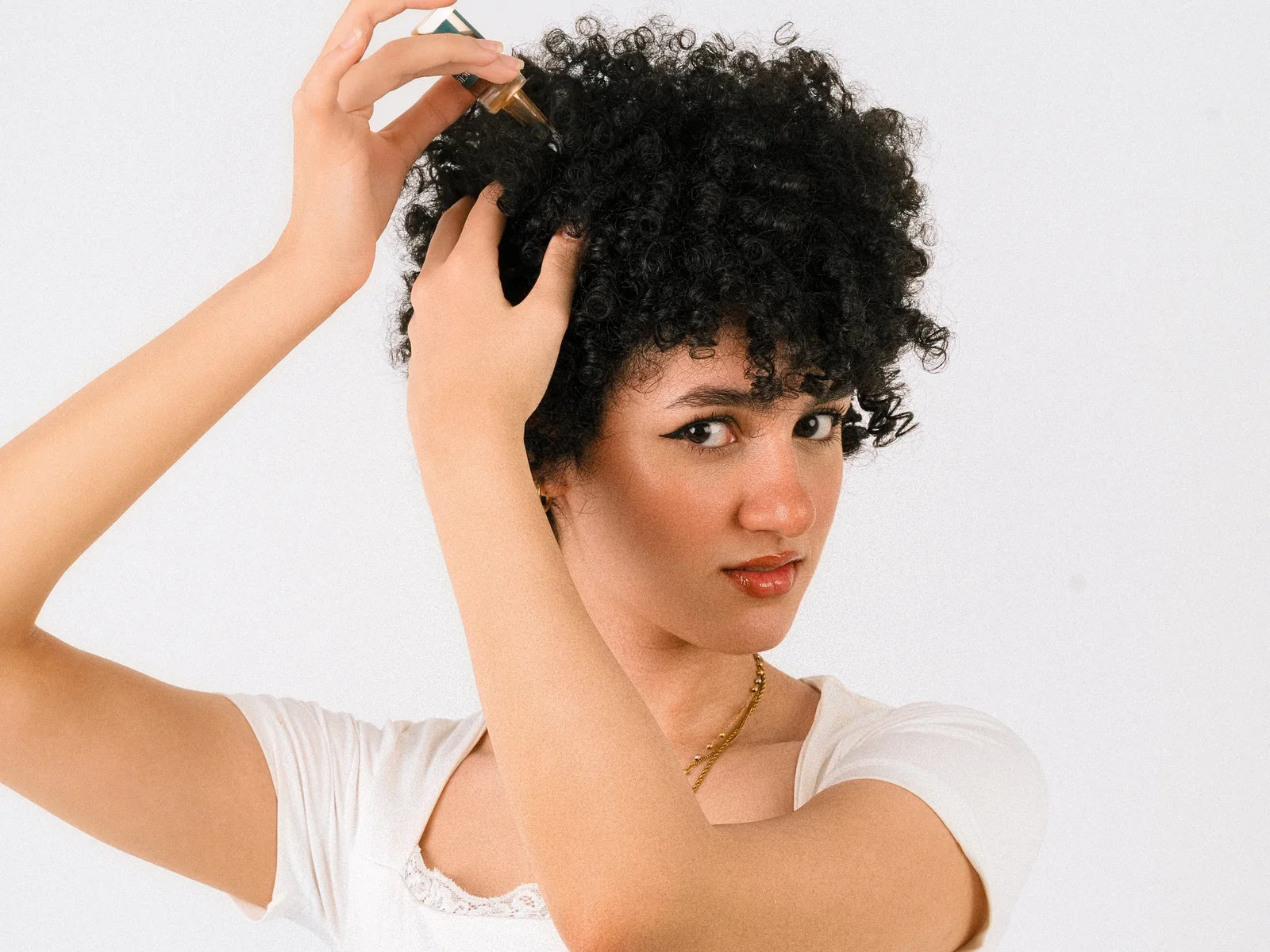 Cactusfy model applying Glow Forever Serum directly to the scalp